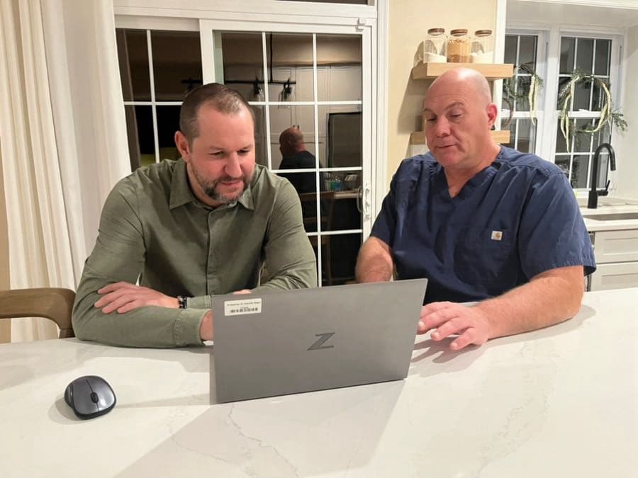 Dr. David DeFries reviewing a patient consultation on a laptop