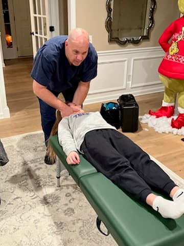 Dr. David DeFries providing in-home chiropractic treatment