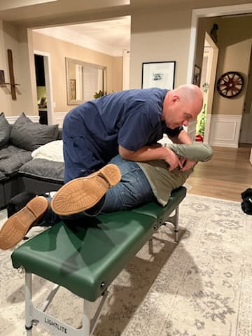 Dr. David DeFries providing chiropractic treatment to a patient during a house call